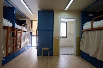 a room with blue bunk beds and a stool at Latroupe Poblenou Beach in Barcelona