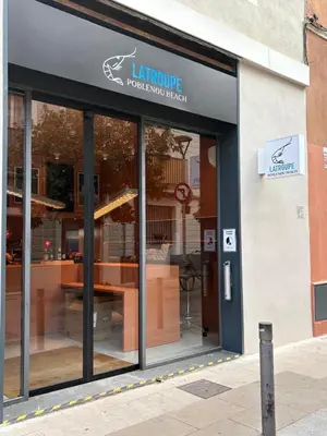 a store front of a restaurant with glass doors at Latroupe Poblenou Beach in Barcelona