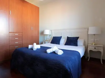 a bedroom with a large bed with towels on it at Classbedroom Fira Business Apartment in Barcelona