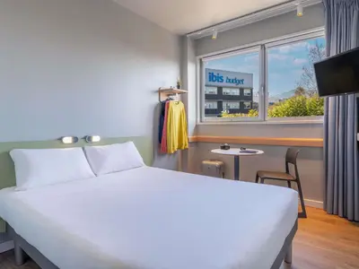 a bedroom with a bunk bed and a table at Ibis Budget Barcelona Viladecans in Viladecáns