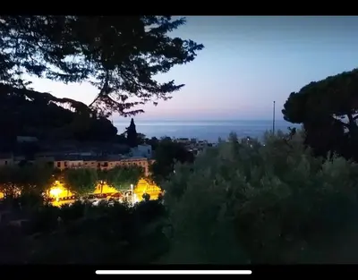 a view of a city at night with lights at Medieval tower & villa by the sea in Caldes d'Estrac