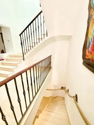a staircase in a house with a painting on the wall at Medieval tower & villa by the sea in Caldes d'Estrac