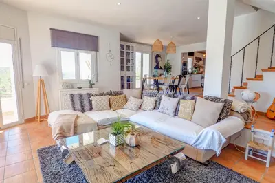 a living room with a couch and a table at Villa Elysian by Hello Homes Sitges in Sant Pere de Ribes