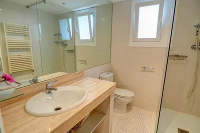 a bathroom with a sink and a toilet and a shower at Tropical Terrace Apartment by Hello Homes Sitges in Sitges