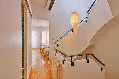 a parrot on the wall of a staircase in a house at Casa de Pueblo junto Barcelona Centro in Vilassar de Dalt