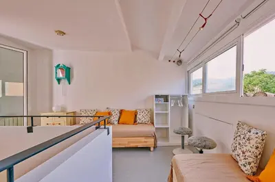 a room with a couch and a bed and a window at Casa de Pueblo junto Barcelona Centro in Vilassar de Dalt