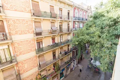 an apartment building with people walking down a street at rentBCN City Center Apartment in Barcelona