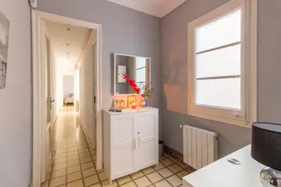 a hallway with a white cabinet and a window at rentBCN City Center Apartment in Barcelona
