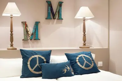 a bedroom with two lamps and a bed with blue pillows at Apartments Barcelona & Home Deco Centro in Barcelona