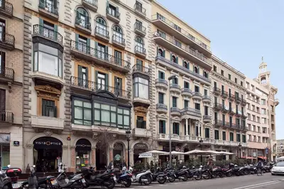 a row of motorcycles parked in front of a building at Apartments Barcelona & Home Deco Centro in Barcelona