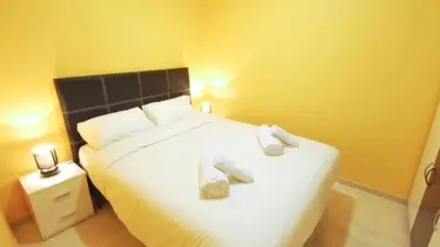 a bedroom with a bed with two towels on it at Homenfun Barcelona Paralelo in Barcelona