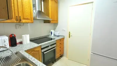a small kitchen with a sink and a stove at Homenfun Barcelona Paralelo in Barcelona