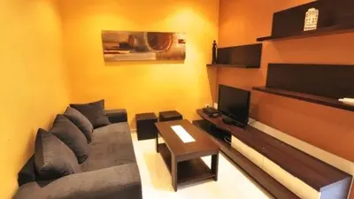 a living room with a couch and a table at Homenfun Barcelona Paralelo in Barcelona