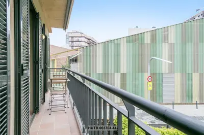 a balcony of a building with a green wall at Alcam Anglesola in Barcelona