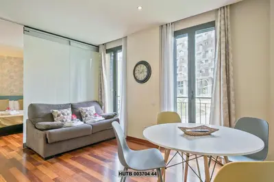 a living room with a table and a couch at Alcam Anglesola in Barcelona
