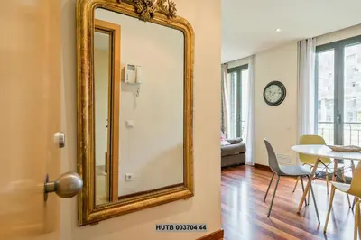 a mirror on the wall of a room with a table at Alcam Anglesola in Barcelona