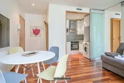 a living room with a table and chairs and a couch at Alcam Anglesola in Barcelona