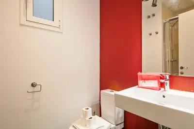 a bathroom with a white sink and a toilet at Alcam Enamorats in Barcelona
