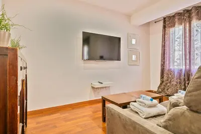 a living room with a couch and a tv at Alcam Enamorats in Barcelona