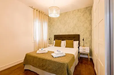 a bedroom with a bed with two towels on it at Alcam Torrent in Barcelona