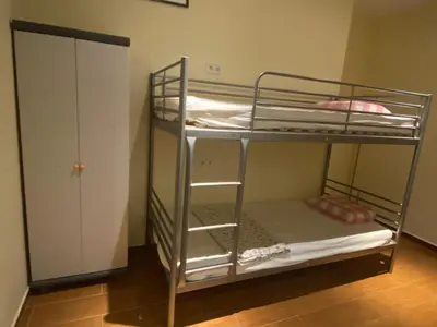 a bunk bed room with two bunk beds and a door at Hostal Granvia 628 in Barcelona