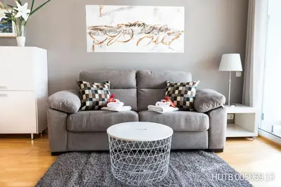 a living room with a couch and a table at Alcam Aribau in Barcelona