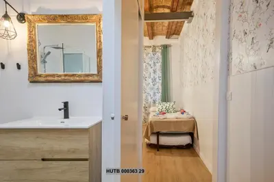 a bathroom with a sink and a mirror and a table at Alcam Gignas in Barcelona