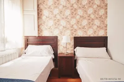 two beds sitting next to each other in a bedroom at Alcam Rizal in Barcelona