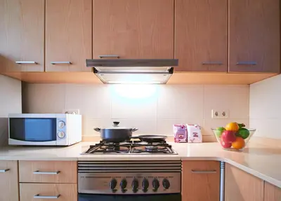 a kitchen with a stove and a microwave at Alcam Valencia II in Barcelona