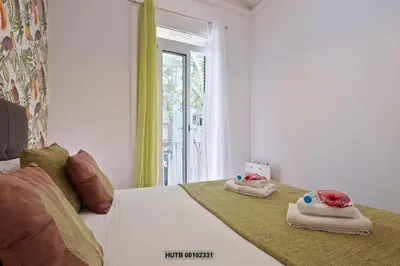 a bedroom with a bed with towels on it at Alcam Montjuic in Barcelona