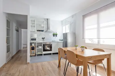 a kitchen and dining room with a table and chairs at Blau Atic Apartment in Barcelona