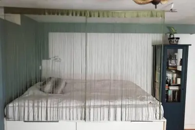a bedroom with a bed with a white comforter at Lovely studio, terrace, swim pool, nature, relax!! in Sant Pere de Ribes