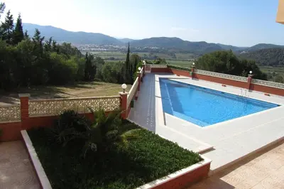 a swimming pool on the side of a house at Lovely studio, terrace, swim pool, nature, relax!! in Sant Pere de Ribes
