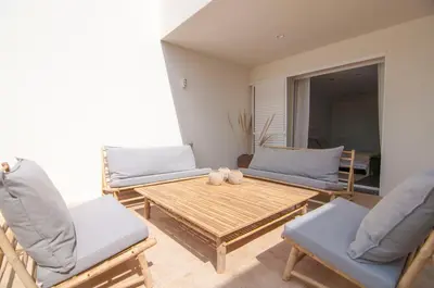 a living room with a wooden table and chairs at Villa Miramar by Glasir in Sitges