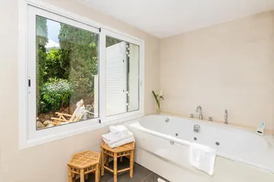 a bathroom with a tub and a large window at Villa Miramar by Glasir in Sitges