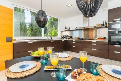 a kitchen with a table with glasses of orange juice at Villa Miramar by Glasir in Sitges