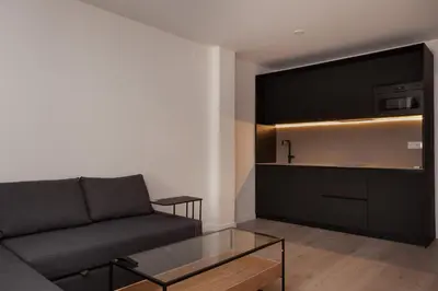 a living room with a couch and a tv at Rambla Catalunya 8 in Barcelona