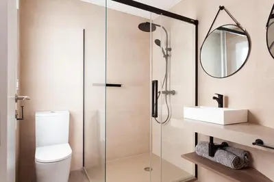 a bathroom with a glass shower with a toilet and a sink at Rambla Catalunya 8 in Barcelona