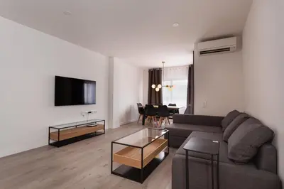a living room with a couch and a tv and a table at Rambla Catalunya 8 in Barcelona