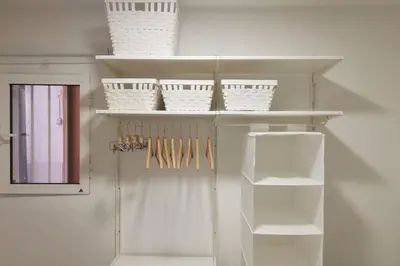 a white shelf with white baskets and utensils at M1 Cool Loft 1 min walk to metro 15 min center by metro in Esplugues de Llobregat