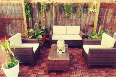 a patio with two couches and a table and plants at M1 Cool Loft 1 min walk to metro 15 min center by metro in Esplugues de Llobregat