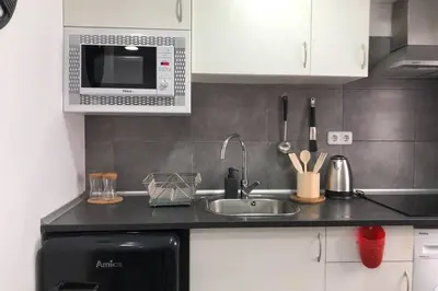 a kitchen with a sink and a microwave at M4 Cool Terrace. 1 min to metro. 15 min to center in Esplugues de Llobregat