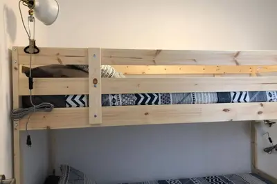 a wooden bunk bed in a room at M4 Cool Terrace. 1 min to metro. 15 min to center in Esplugues de Llobregat