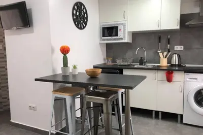 a kitchen with a black counter and a sink at M4 Cool Terrace. 1 min to metro. 15 min to center in Esplugues de Llobregat
