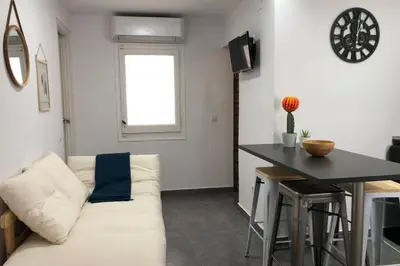 a living room with a white couch and a table at M4 Cool Terrace. 1 min to metro. 15 min to center in Esplugues de Llobregat