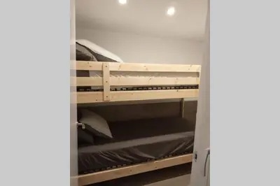 ajar view of a room with a bunk bed at M2 Cool apartment next to metro. 15m to center in Esplugues de Llobregat