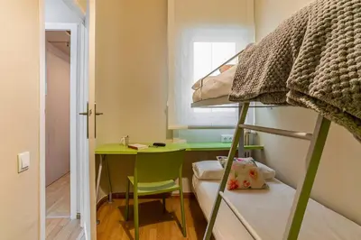 a small room with a desk and a bunk bed at 731 - AB Enric Granados Apartment in Barcelona