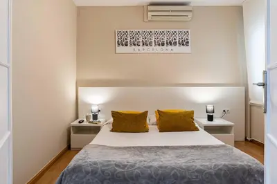 a bedroom with a bed with two night stands and two lamps at 731 - AB Enric Granados Apartment in Barcelona