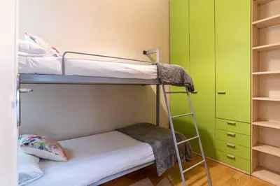 a bunk bed in a room with green walls at 731 - AB Enric Granados Apartment in Barcelona