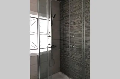 a bathroom with a shower with a glass door at M3 Terrace. Cool apartment 15 min center by metro in Esplugues de Llobregat
